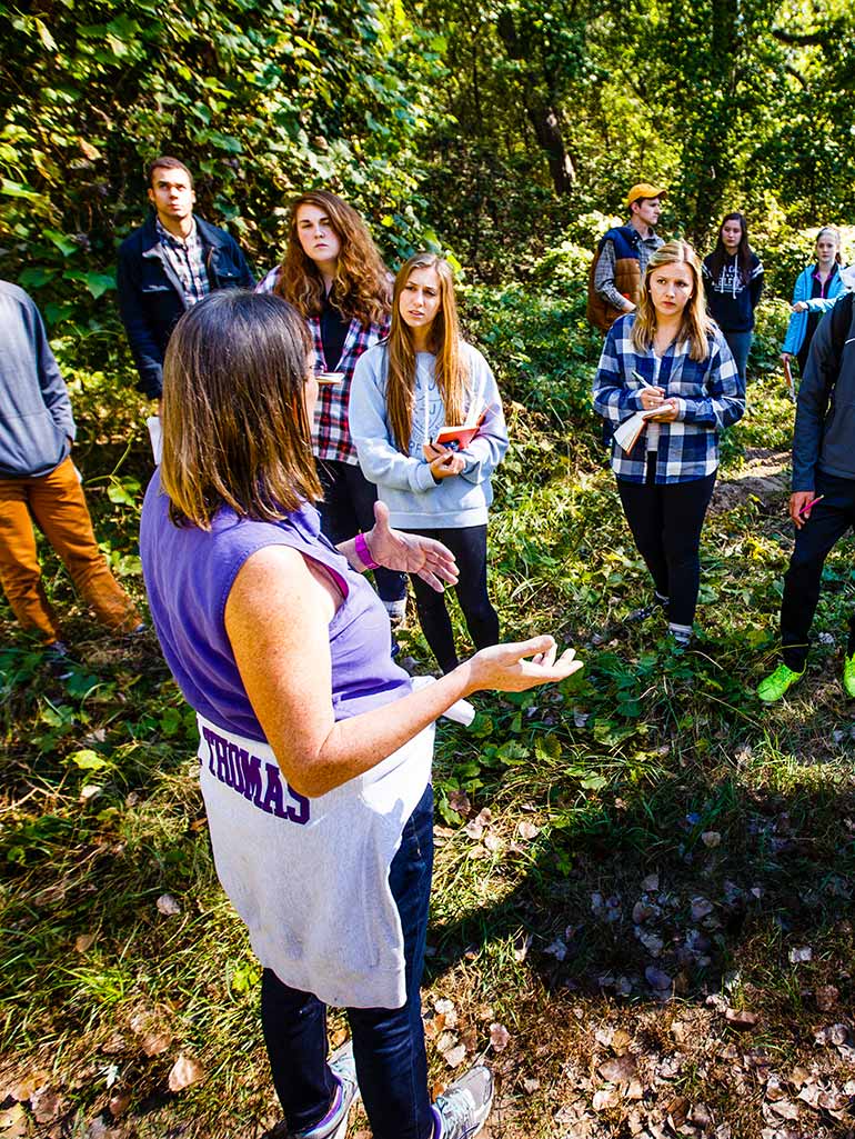 Geology Ҵý Lisa Lamb instructs members of the Sustainability Living Learning Community (LLC) during a soils lab at Hidden Falls Park.